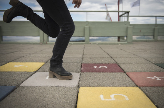 A game of hopscotch drawn on the pavement with numbers on the tiles