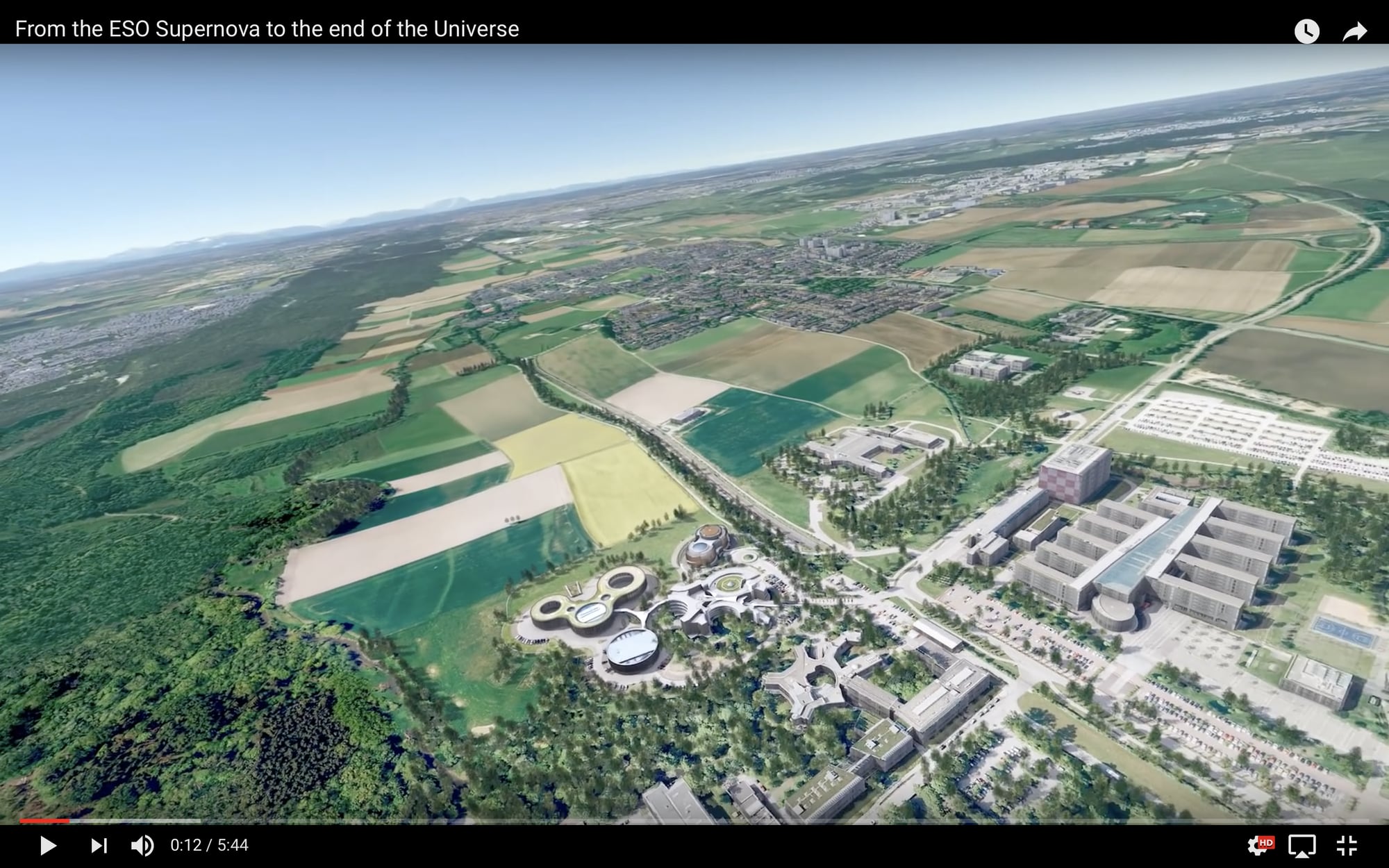 Aerial simulation view of the ESO Supernova Planetarium campus in Germany transitioning towards a cosmological view of the surrounding landscape.
