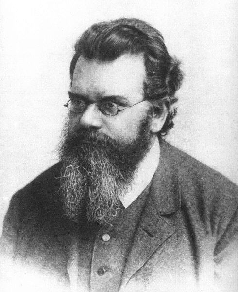 Black and white photographic portrait of Austrian physicist Ludwig Boltzmann wearing spectacles with a full, bushy beard.